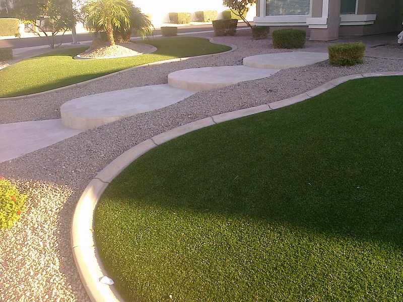 Artificial grass and concrete stairs in front yard