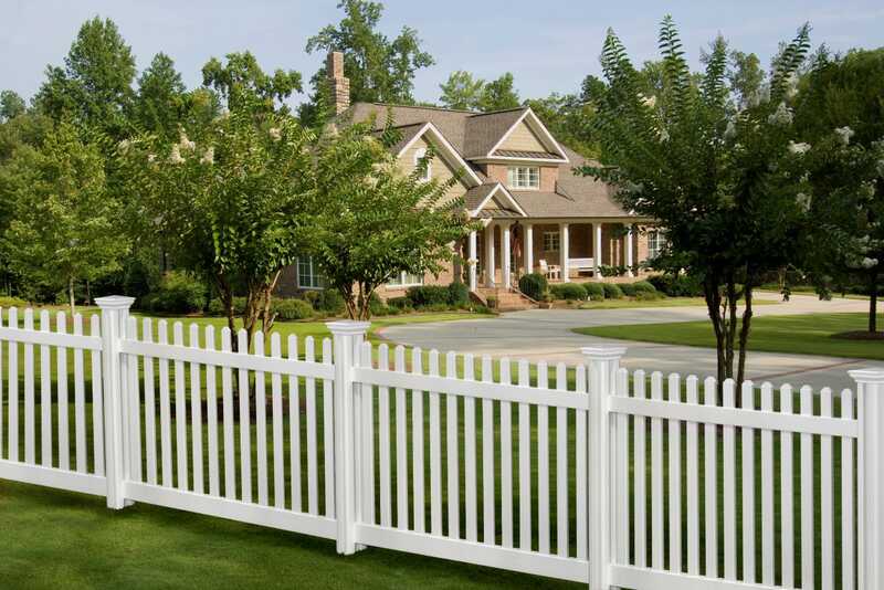 A white vinyl fence of a house