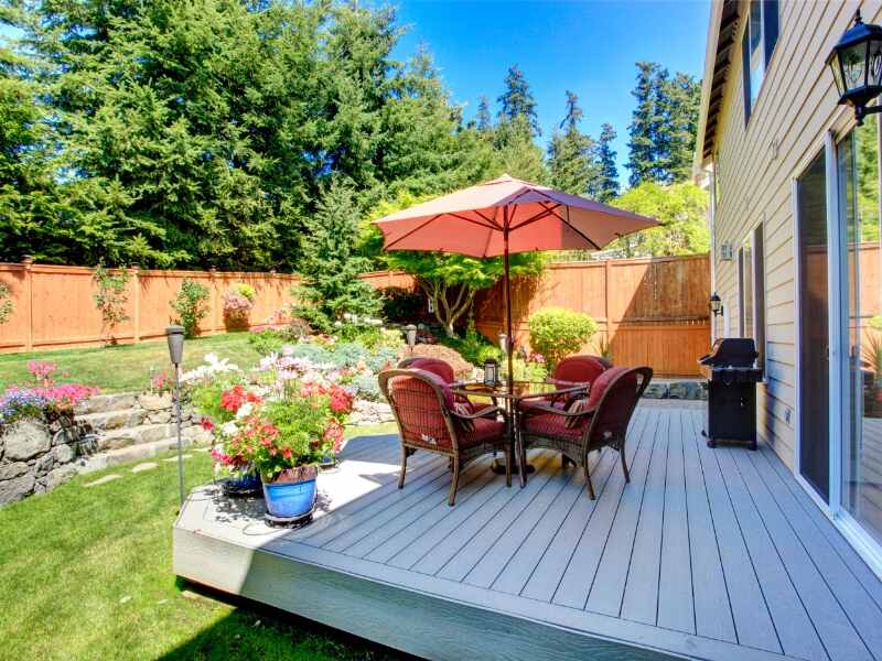 backyard patio with landscaping and bistro set